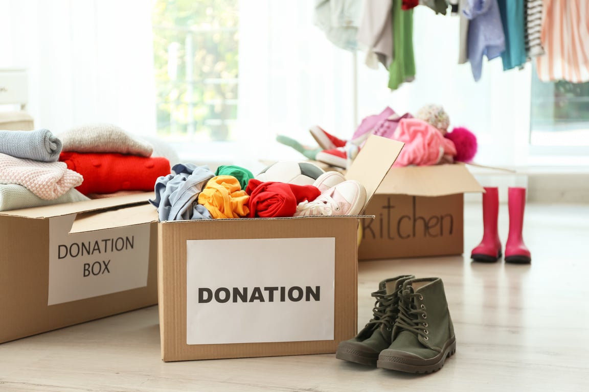 Donation Boxes with Clothes on Floor Indoors